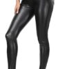 A stylish model wearing premium Nocturne Noir real lambskin leather wide-leg pants with deep pockets and brown boots.