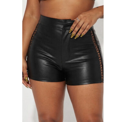 A close-up studio photograph of a model wearing high-waisted, black real leather shorts. The shorts feature a high waistband and intricate.