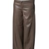 A person wearing brown real leather wide leg trousers paired with a light top